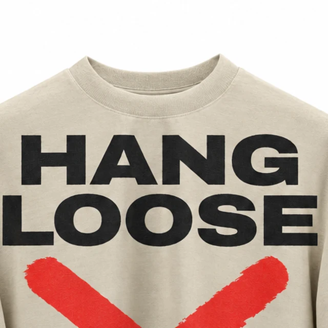 The ribbed crew neck of the beige oversized hanging T-shirt above its HANG LOOSE print