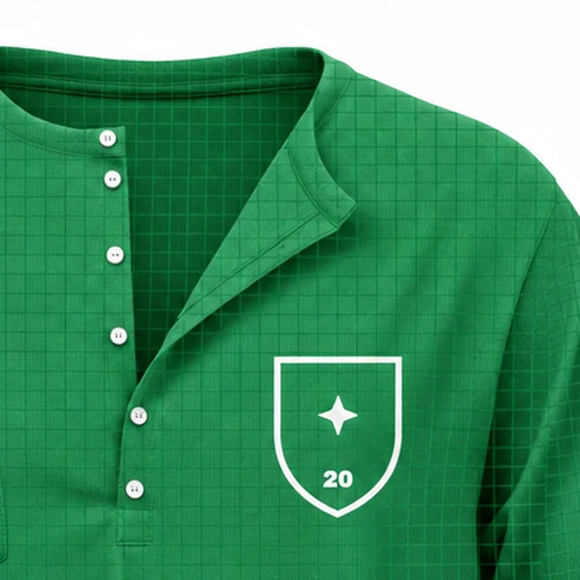 The buttoned placket and shield print of the green oversized Henley shirt